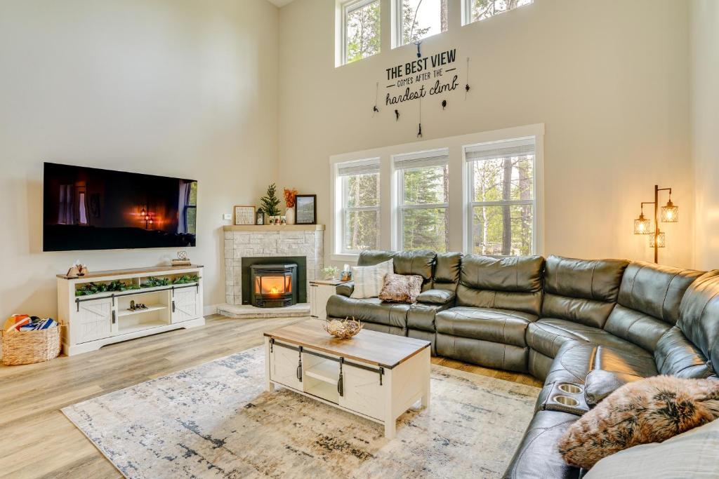a living room with a couch and a fireplace at Spacious Donnelly Family Home with Private Hot Tub! in Donnelly