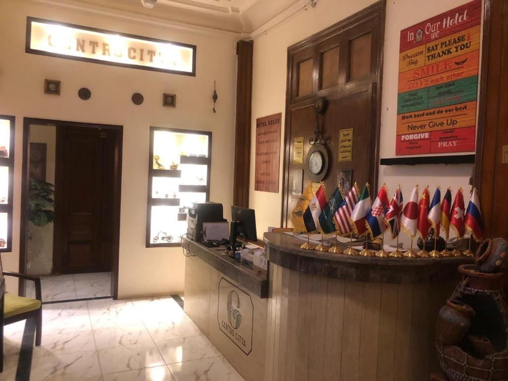 a restaurant with a counter with american flags on it at Centro Citta Hotel in Cairo