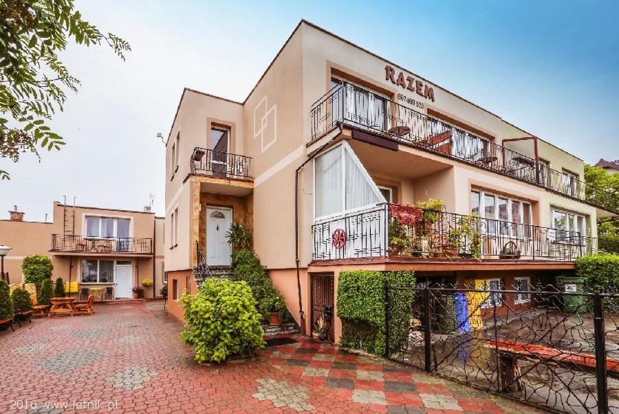an apartment building with balconies and a courtyard at Pokoje Gościnne Razem 10 min do plaży in Władysławowo