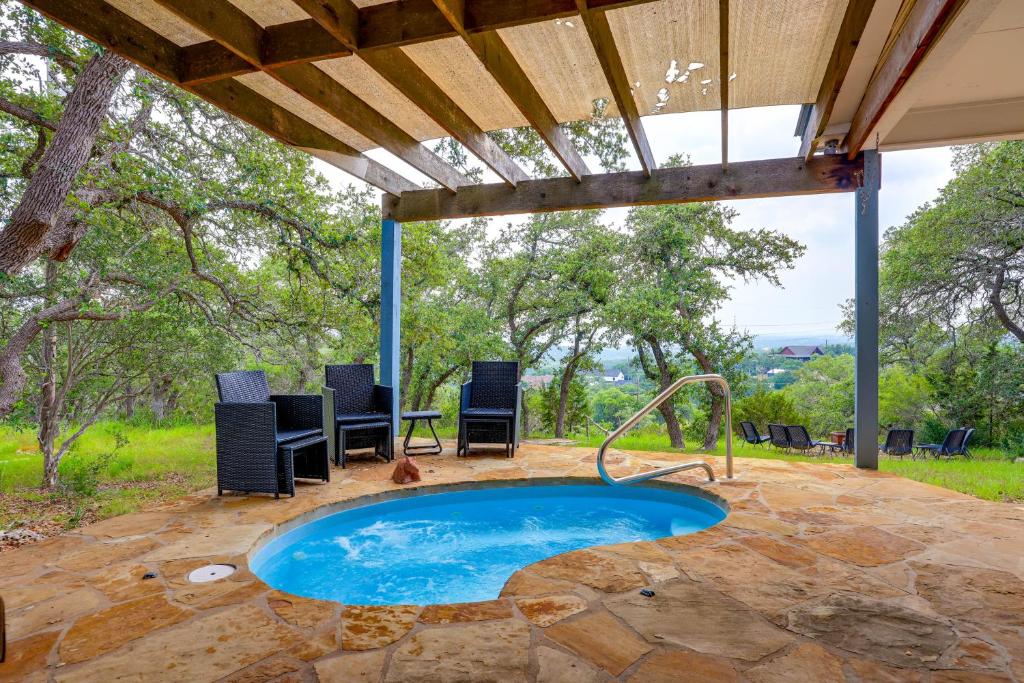 a swimming pool in the middle of a patio at Modern Fischer House with Deck, Fire Pit and Hot Tub! in Fischer