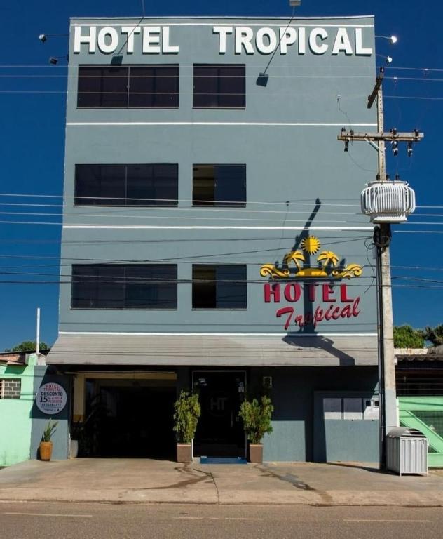 a hotel with a sign on the side of a building at Hotel Tropical in Porto Velho