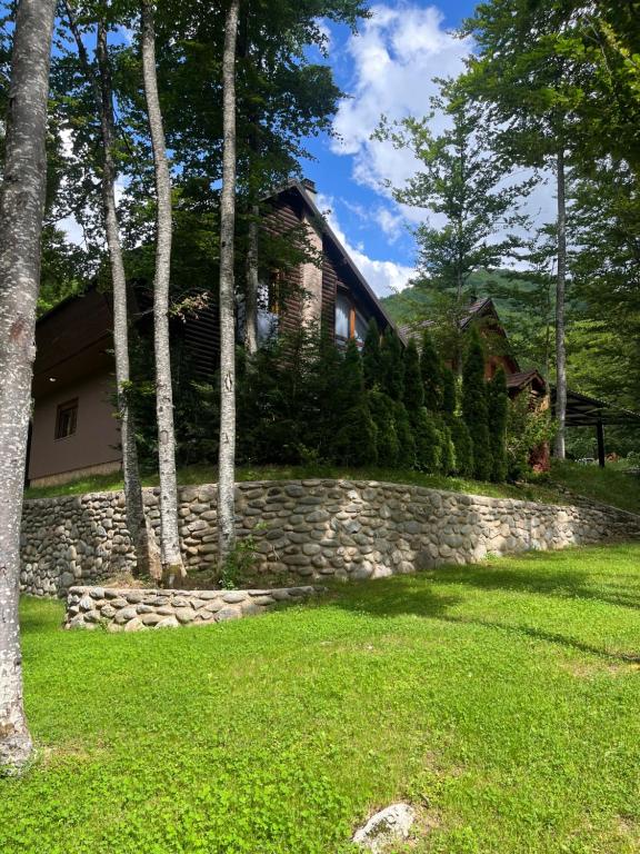 uma casa com uma parede de pedra e árvores em Villa in Brezovica em Brezovica