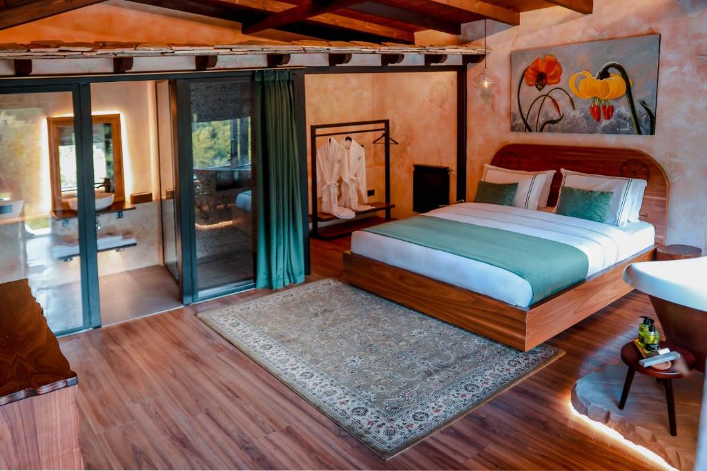 a bedroom with a bed and a bathroom at Hotel Thethi in Theth