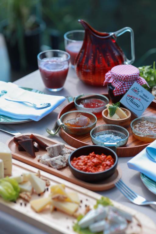 a table topped with plates of food on a table at Hotel Thethi in Theth