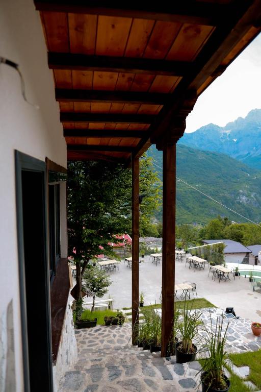 a building with a patio with a view of a courtyard at Hotel Thethi in Theth