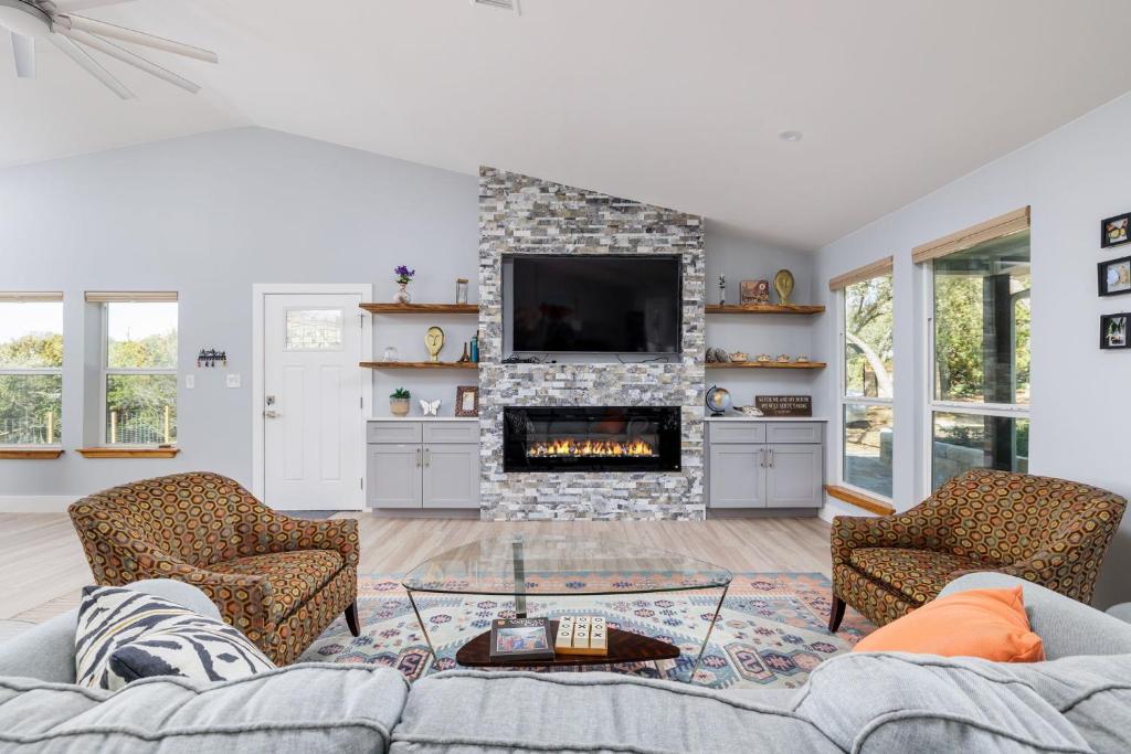 a living room with a couch and a fireplace at Casa Mariposa Newly Renovated Firepit*Fireplace*Great Deck*Pets Welcome! in Bee Cave
