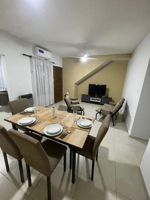 a dining table and chairs in a living room at Encanto floral 2Pax - By Inside in Guaymallen