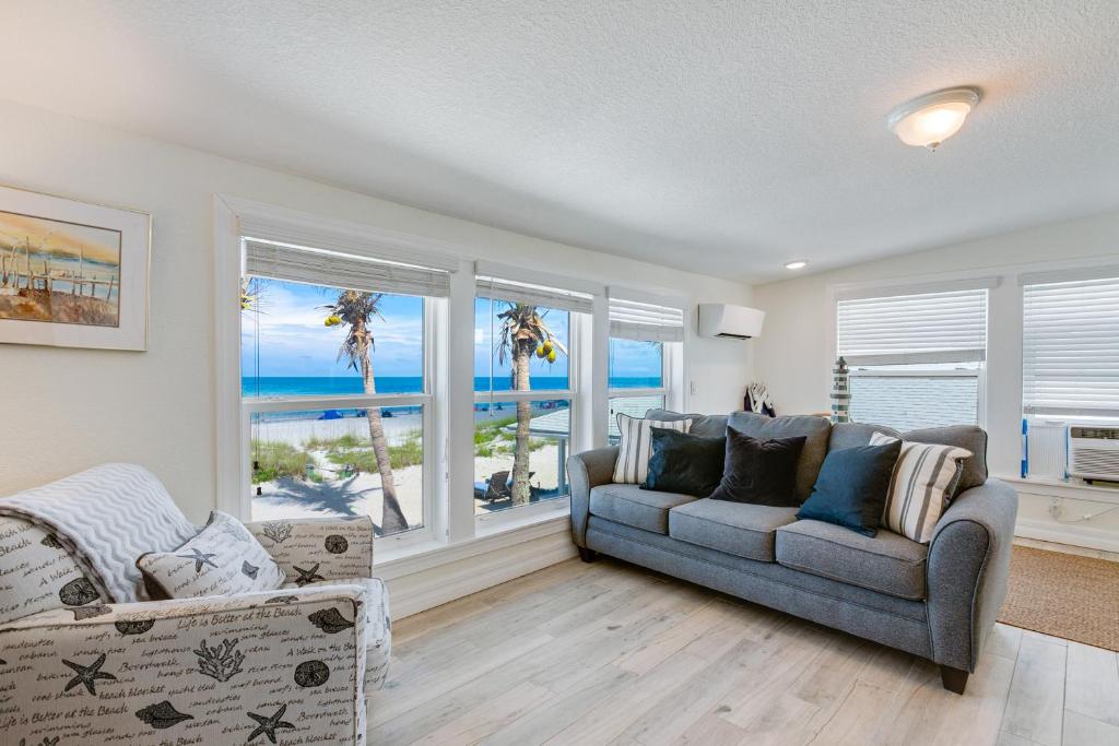a living room with a couch and a view of the ocean at Beach Dreams Resort in Bradenton Beach