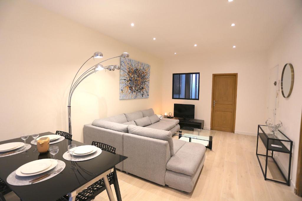 un salon avec un canapé et une table dans l'établissement Atypique T3 Clim 80m2 avec Patio, à Marseille