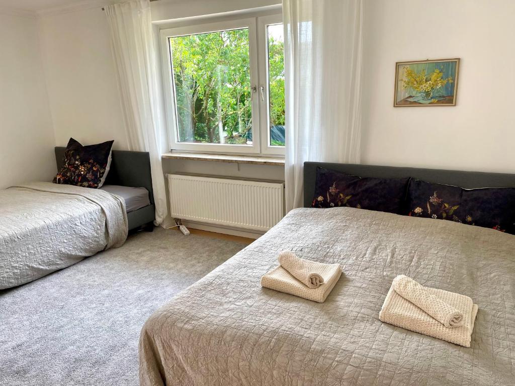 a bedroom with two beds and a window at Aubing Süd in Munich