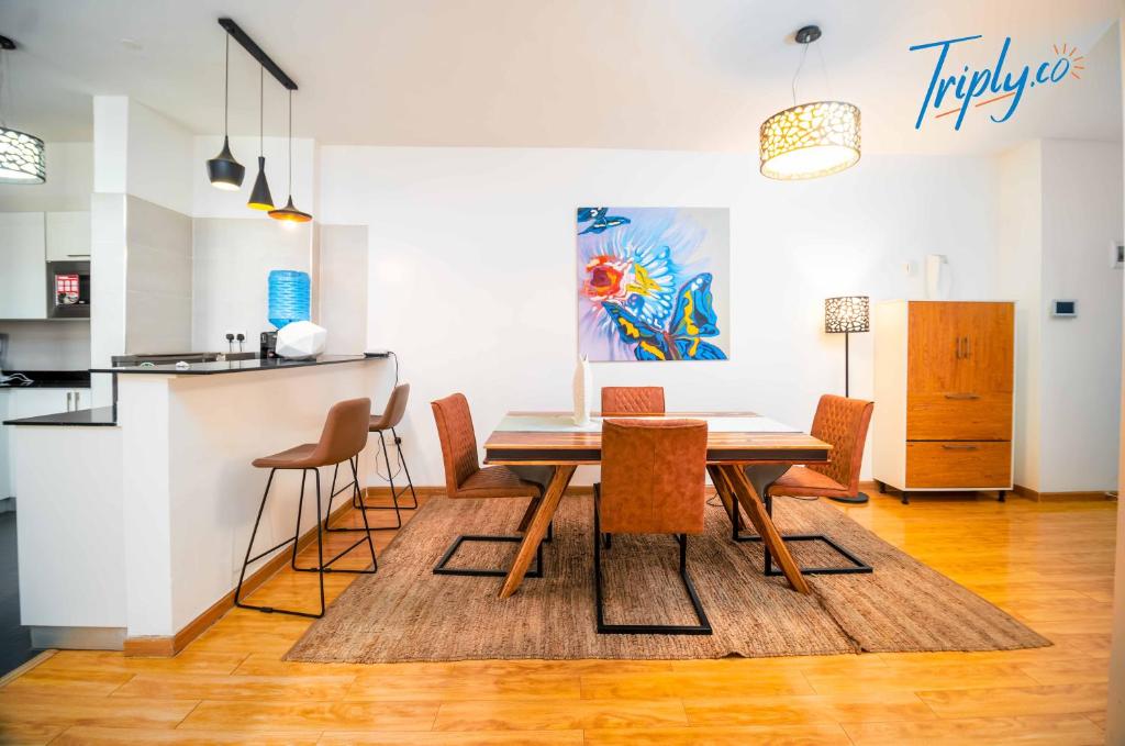 une cuisine et une salle à manger avec une table et des chaises dans l'établissement Soho B21, à Nairobi