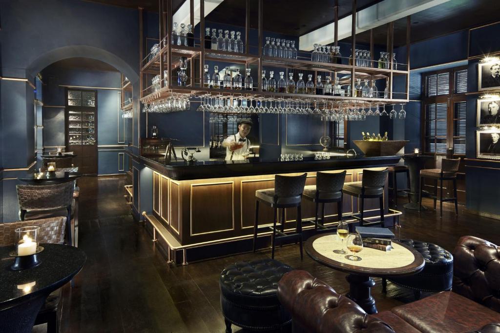 a restaurant with a bar with tables and chairs at Anantara Chiang Mai Resort in Chiang Mai
