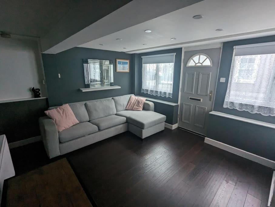 a living room with a couch and a window at Free Parking, 1 bed flat Park street in Weymouth