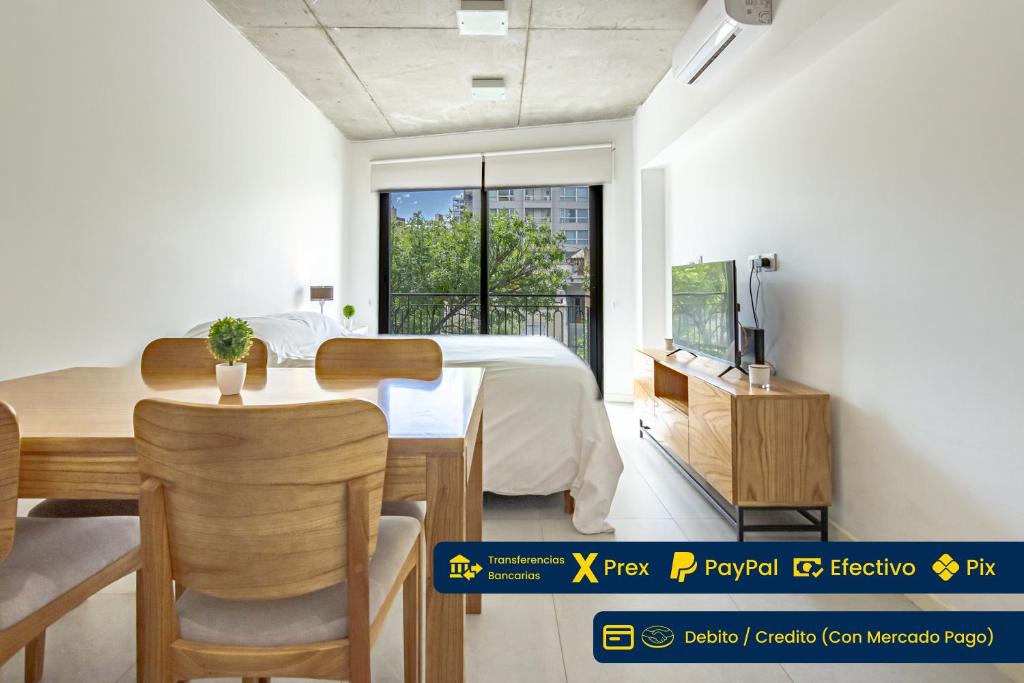 a bedroom with a bed and a table and a tv at Elegancia y Confort en el Corazón de San Telmo in Buenos Aires