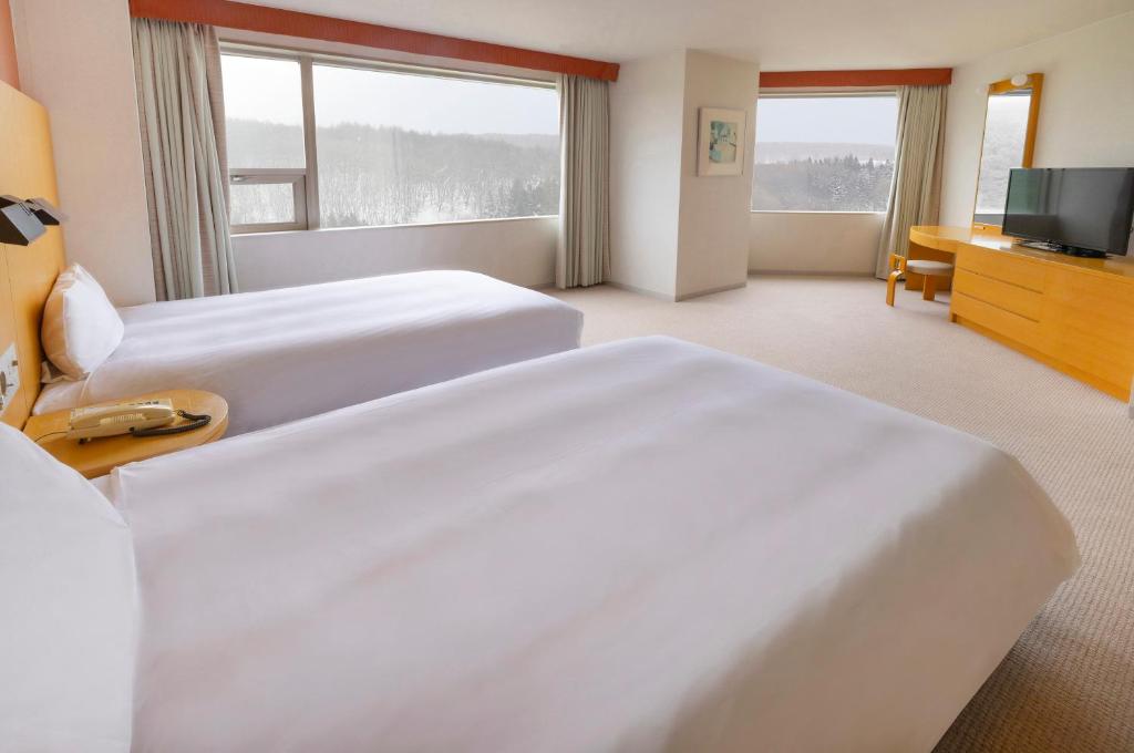 Gulta vai gultas numurā naktsmītnē ANA Crowne Plaza Resort Appi Kogen, an IHG Hotel