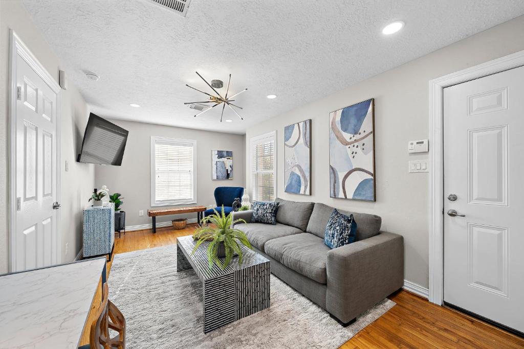 a living room with a couch and a table at The Carriage House Retreat in Houston