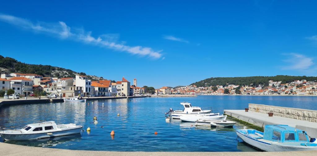 a group of boats are docked in a harbor at Apartments Valentina Tisno in Tisno