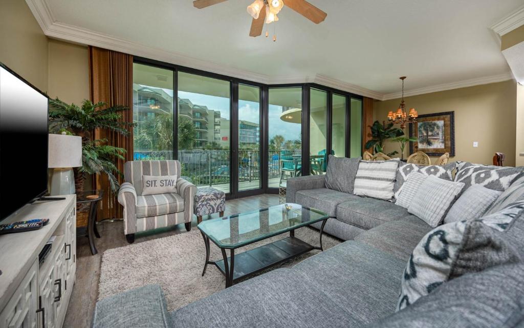 a living room with a couch and a table at Phoenix on the Bay 1214 condo in Orange Beach