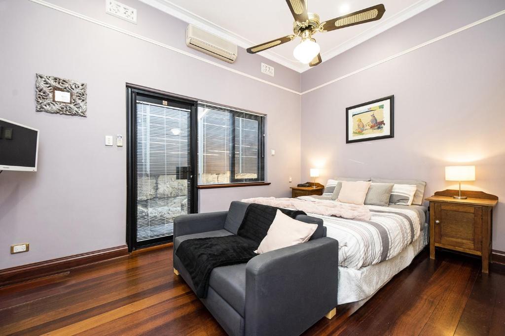 a bedroom with a bed and a couch at Dawson Accommodation in Fremantle