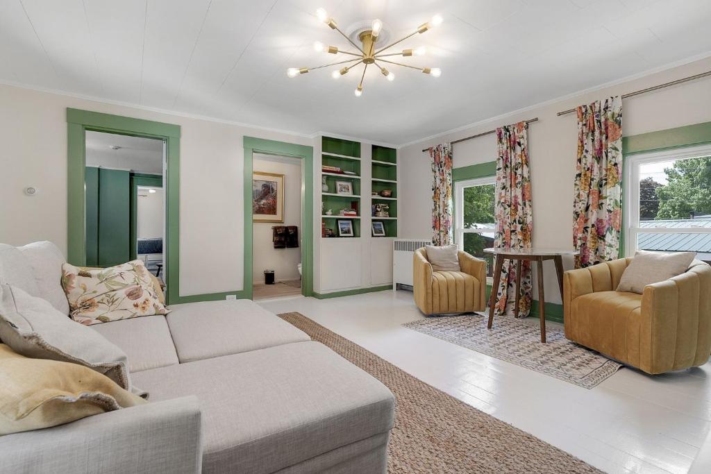 a living room with a couch and two chairs at GAGE FARMHOUSE LIMIT 6 apts in Bridgton