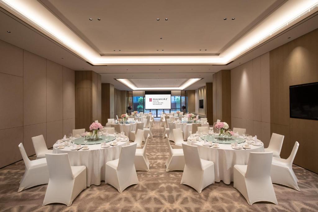 a conference room with white tables and white chairs at InterContinental Xi'an Hi-Tech Zone in Xi'an