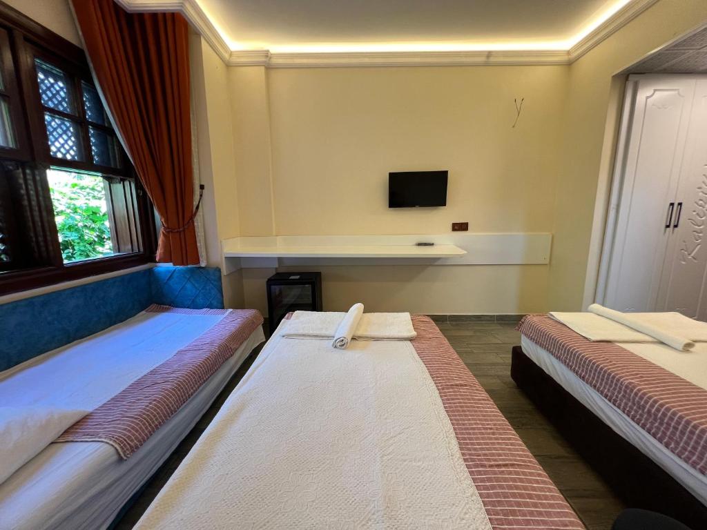 Postel nebo postele na pokoji v ubytování Kaliptus Hotel