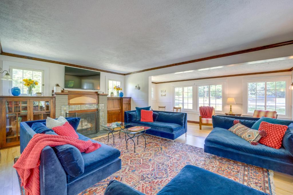 a living room with blue couches and a fireplace at 4 Mi to Shanty Creek Family Home with Game Room in Bellaire