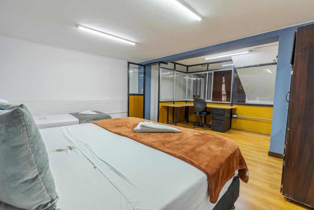 Postel nebo postele na pokoji v ubytování Poblado Guest House