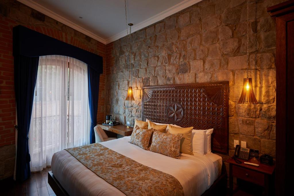 Postel nebo postele na pokoji v ubytování Hotel Otavalo