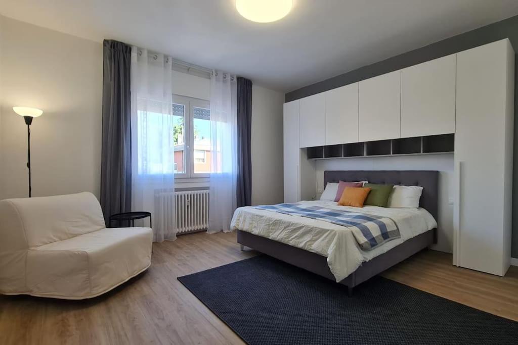 a bedroom with a bed and a couch and a chair at FREE PARK Hapton house Big Mama - Easy to Venice in Mestre