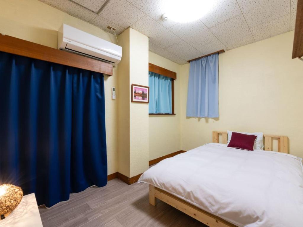 Postel nebo postele na pokoji v ubytování Travel Inn Kofu