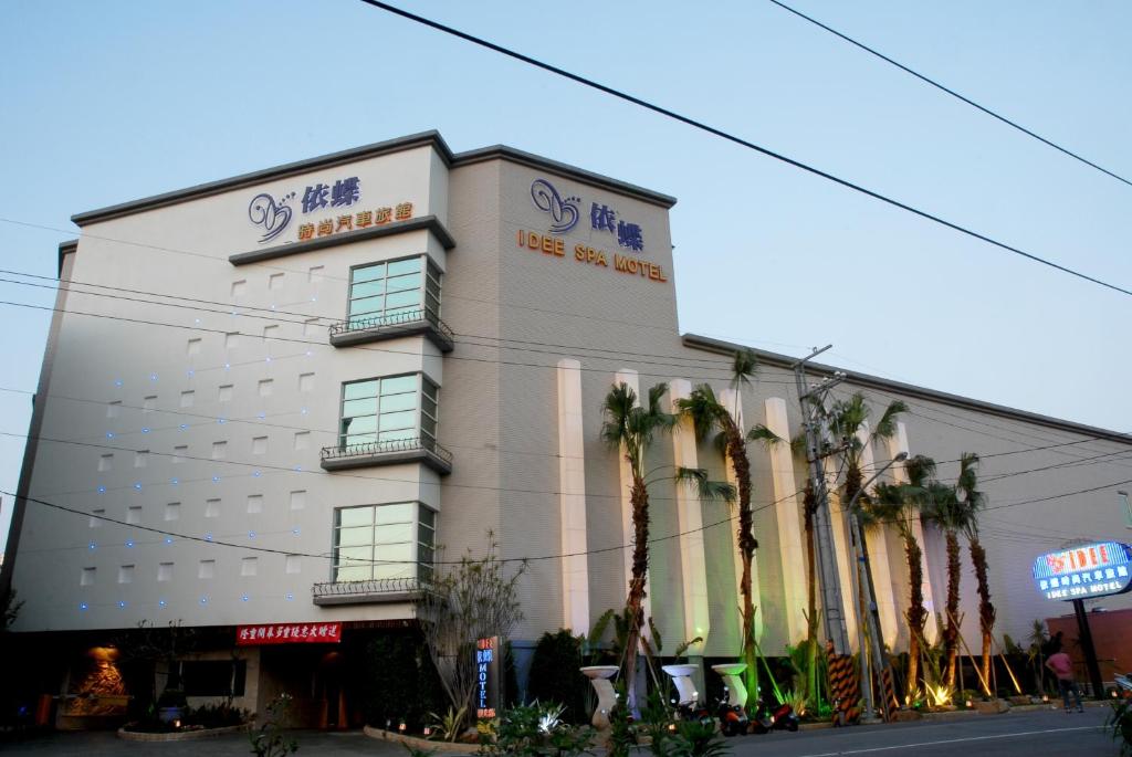 un edificio con palmeras delante en Idee SPA Motel, en Yangmei