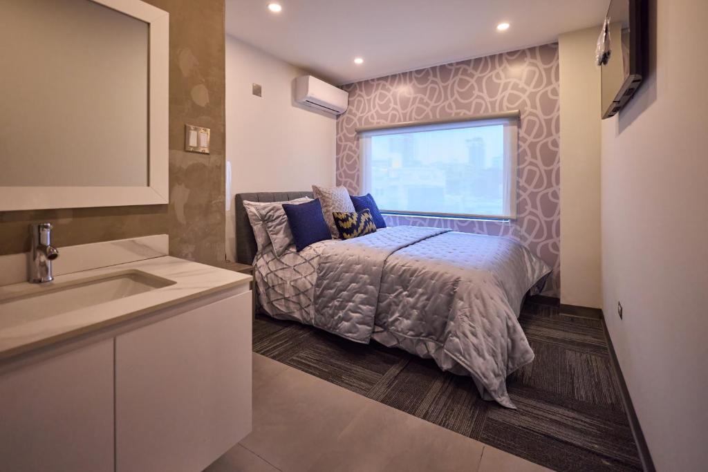 Postel nebo postele na pokoji v ubytování Ola Boutique Hotel