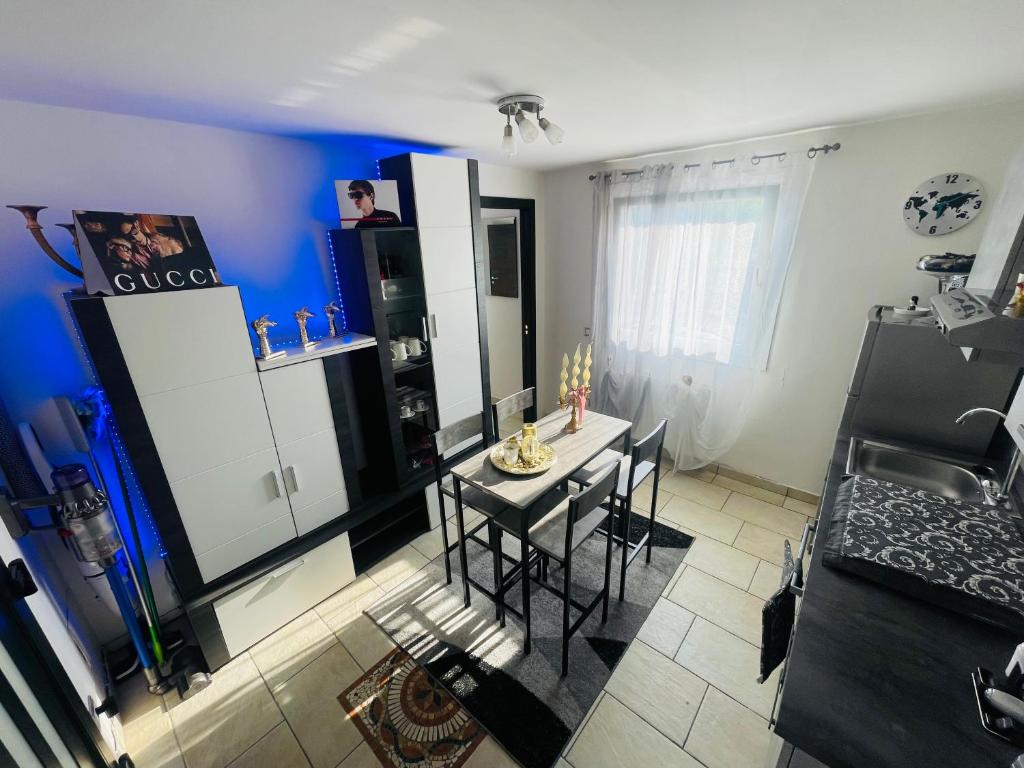 Habitación con mesa, sillas y pared azul. en Incredibile Appartamento con doccia Idromassaggio 