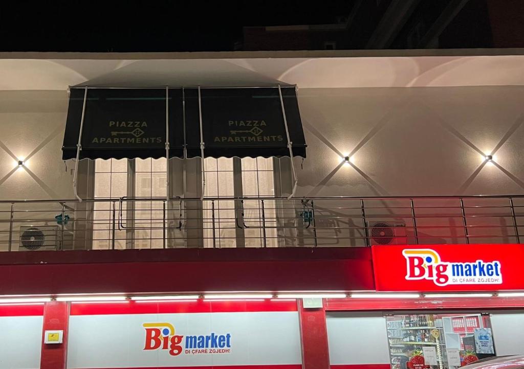 a big market sign on top of a store at Piazza Apartments in Velipojë