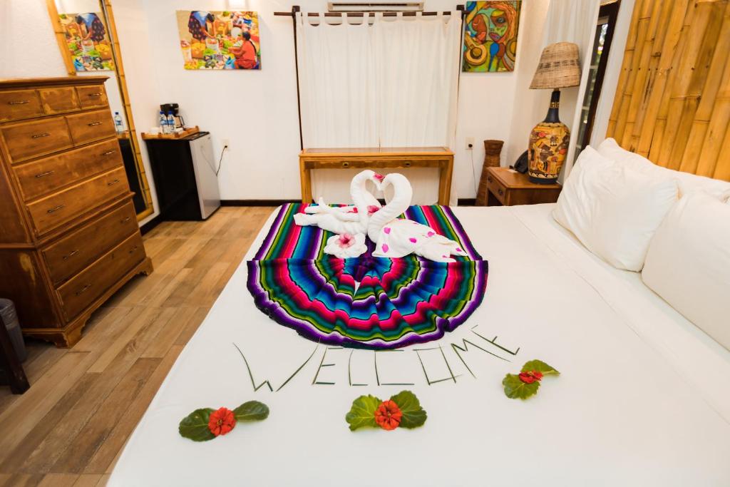 a bedroom with a bed with a wii sign on it at Falling Leaves Lodge in San Ignacio