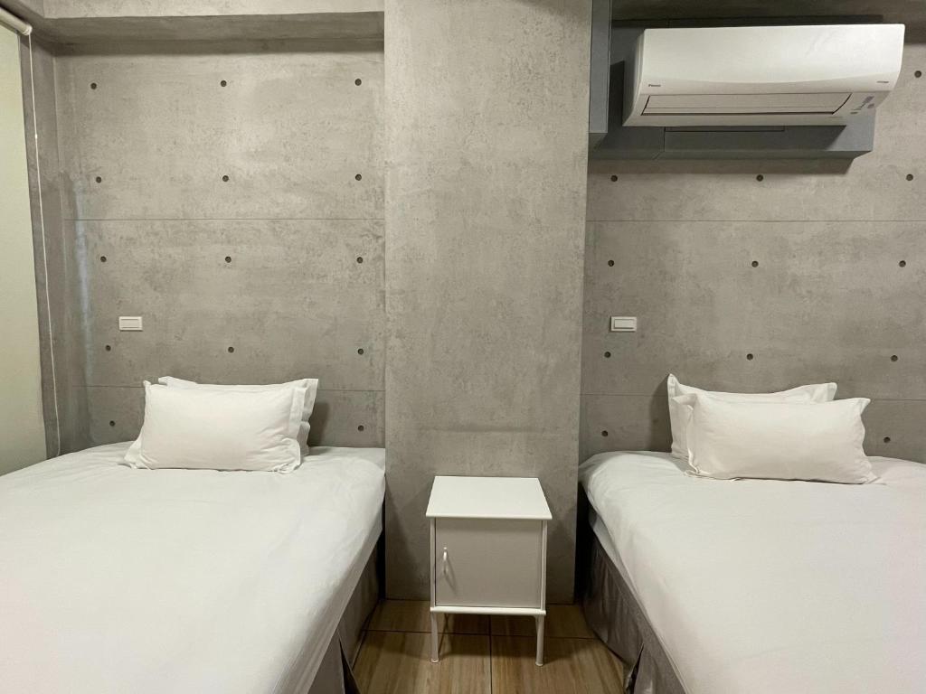 Voodi või voodid majutusasutuse Mei Jen Home B&B 民宿 toas
