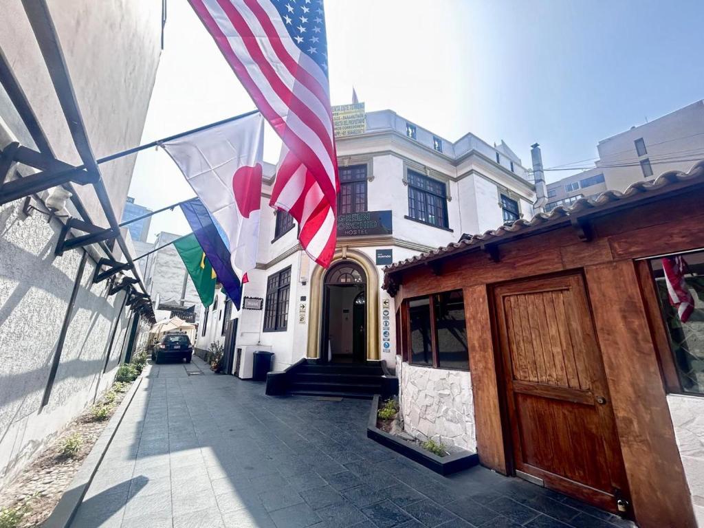 a building with american flags on the side of a street at GREEN ORCHID HOSTEL Miraflores Lima in Lima
