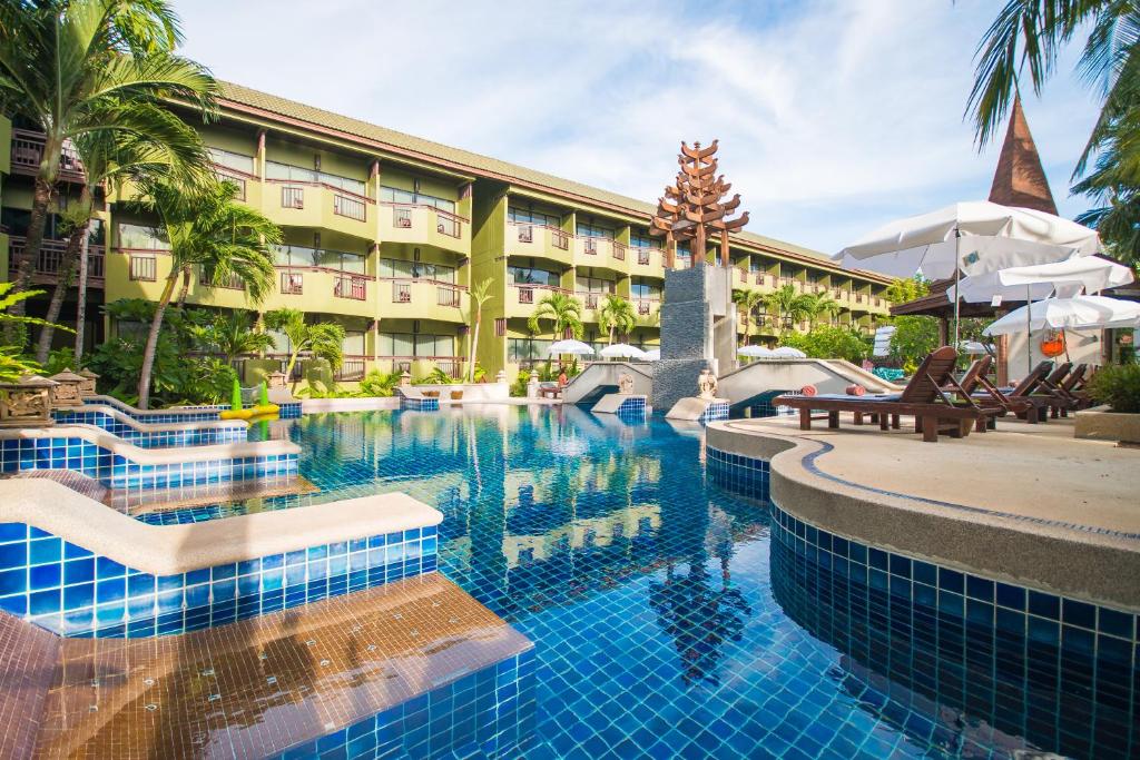 a pool at the resort with chairs and umbrellas at Phuket Island View Resort - SHA Extra Plus in Karon Beach