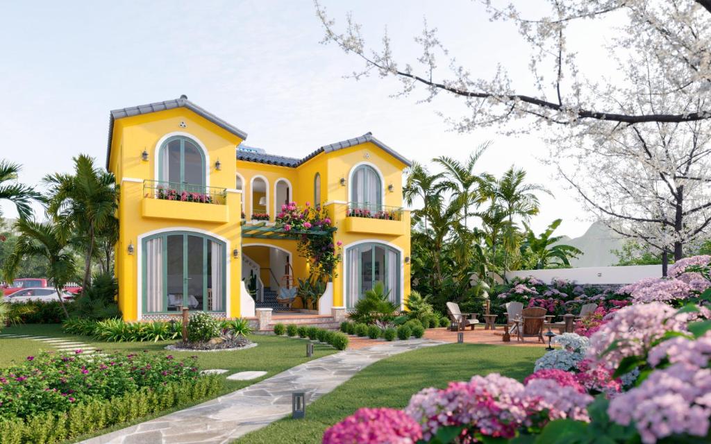 a yellow house with flowers in front of it at Plum Village Moc Chau in Mộc Châu