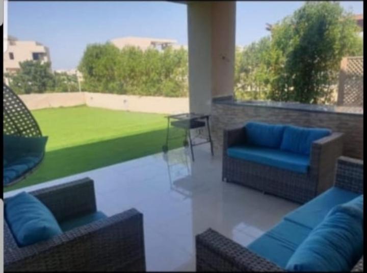 a patio with two couches and a view of a lawn at Hacienda bay in El Alamein