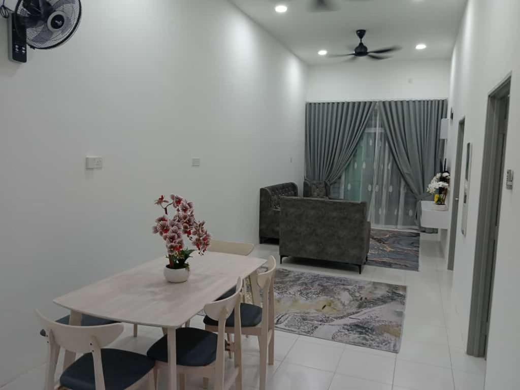 a dining room table and chairs in a room at Amara Homestay Kuantan Airport in Kuantan