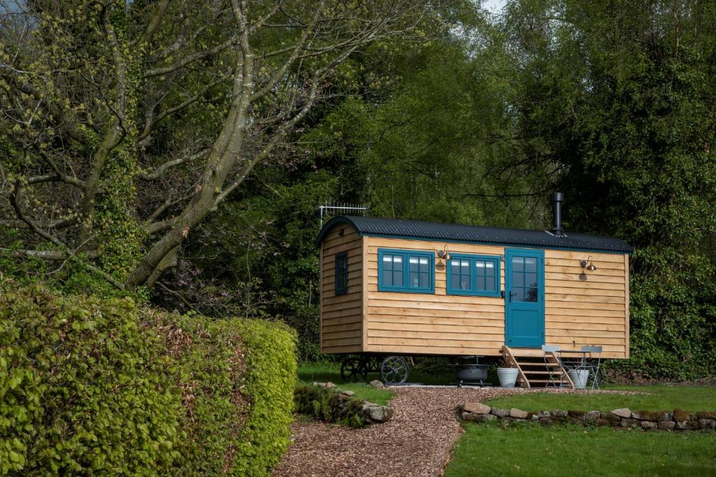 a tiny house is sitting in a yard at Stag Shepherds HutChatsworth Estate in Baslow
