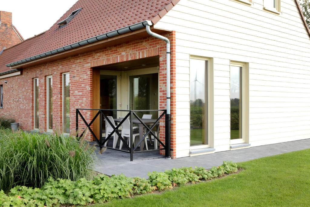 une véranda couverte d'une maison avec une terrasse dans l'établissement Back2Front, à Boezinge