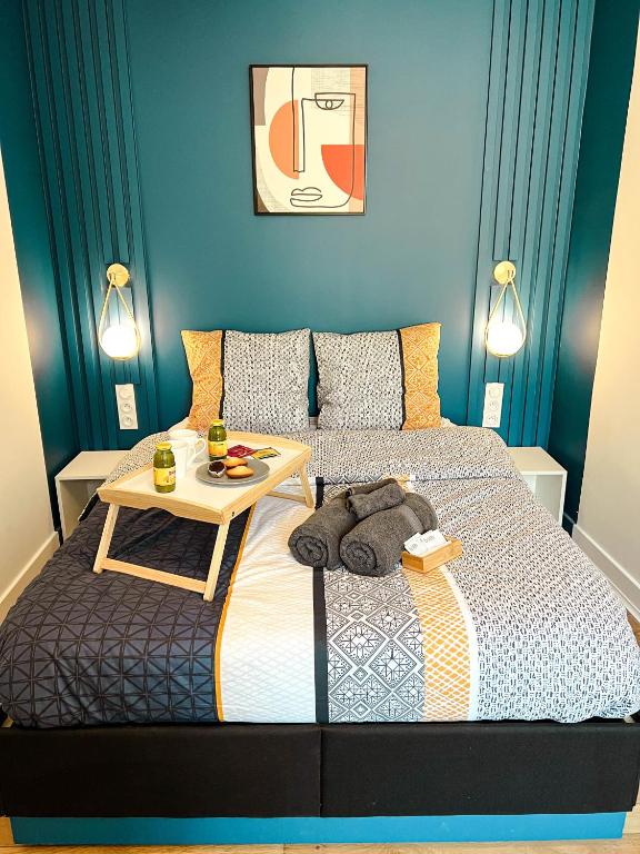 - une chambre avec un lit et une table dans l'établissement Le cosy et confortable à 15min à pied de la gare, à Valence