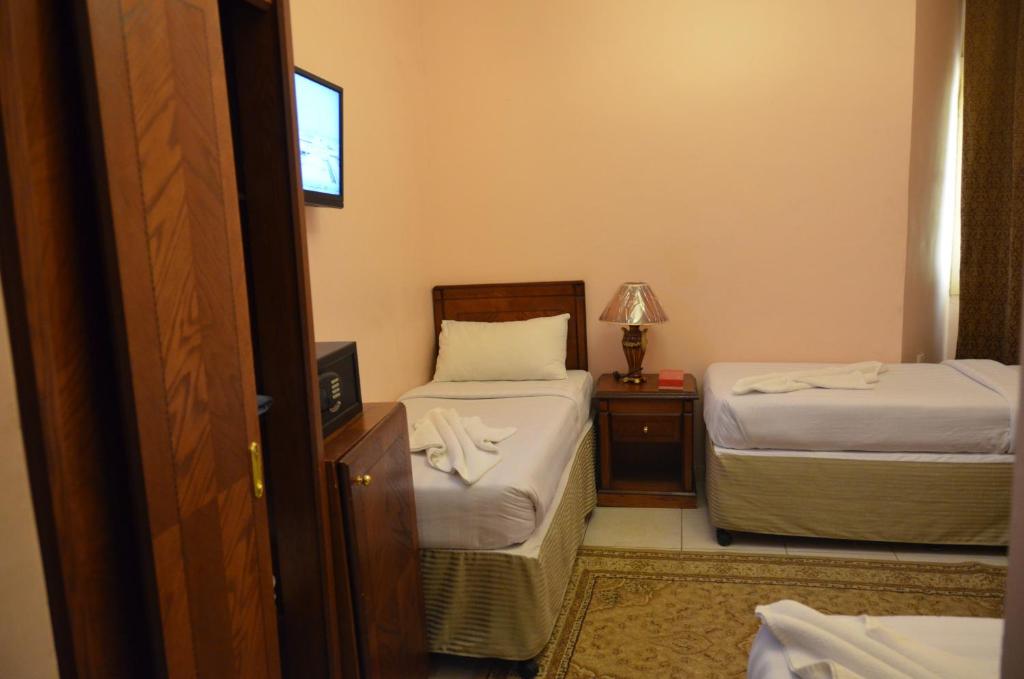 Ein Bett oder Betten in einem Zimmer der Unterkunft Rakhaa Al Deafah Hotel