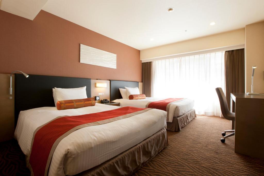 Postel nebo postele na pokoji v ubytování Hotel Sardonyx Tokyo