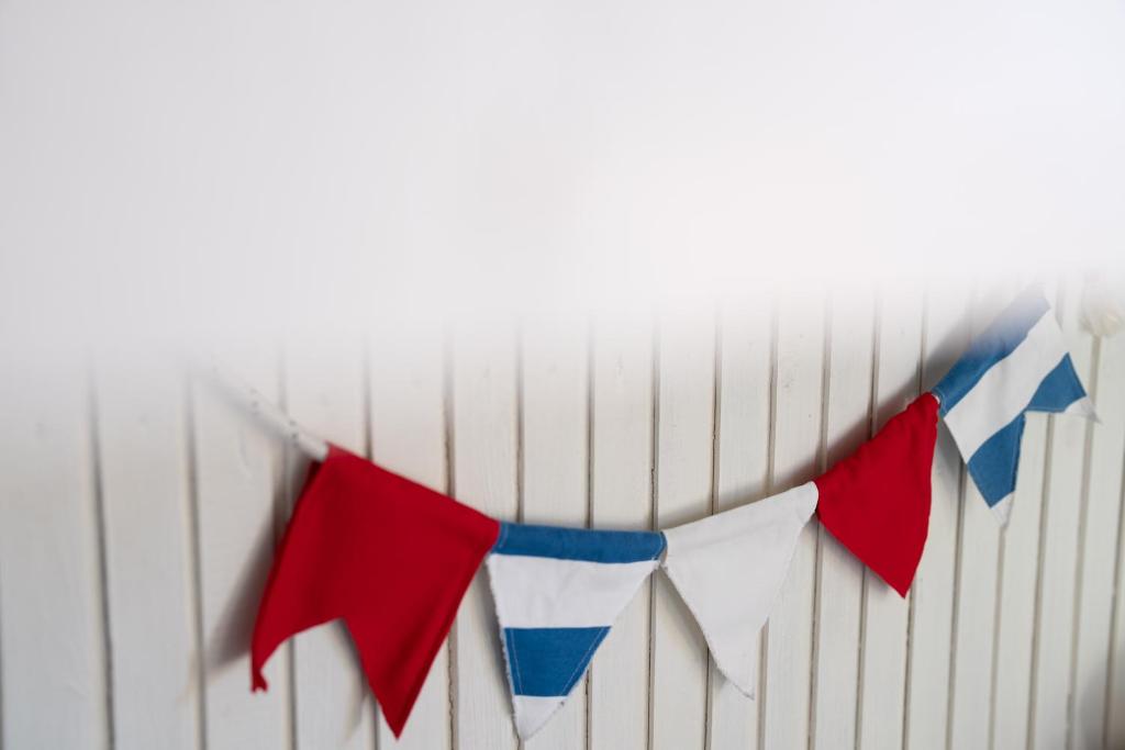a bunch of flags hanging on a wall at Guboja in Nida