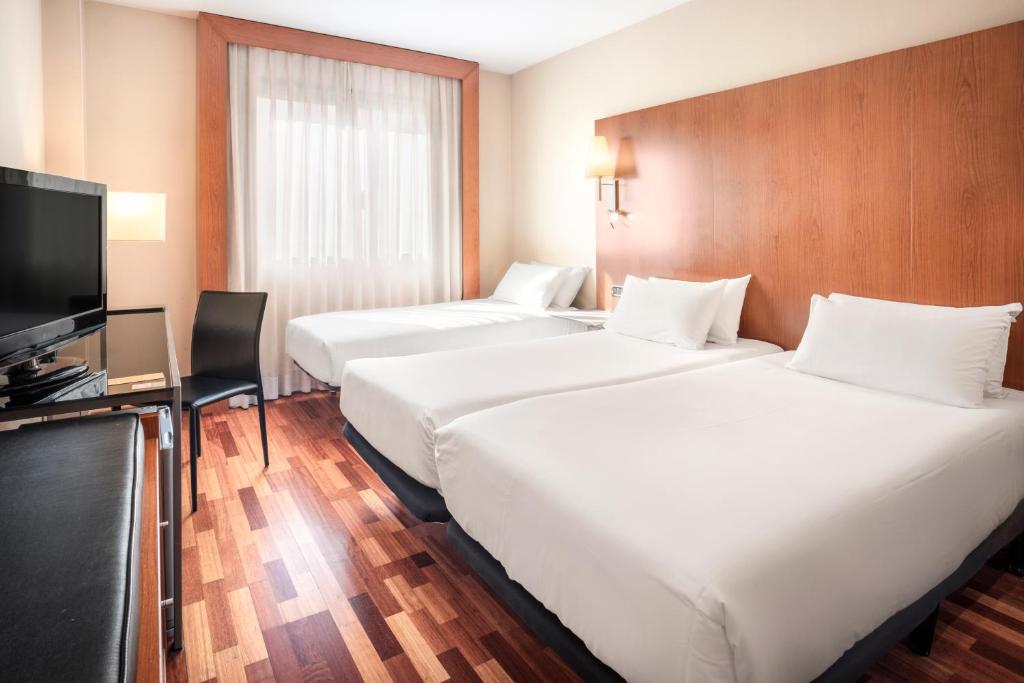 Postel nebo postele na pokoji v ubytování B&B HOTEL Ciudad de Lleida