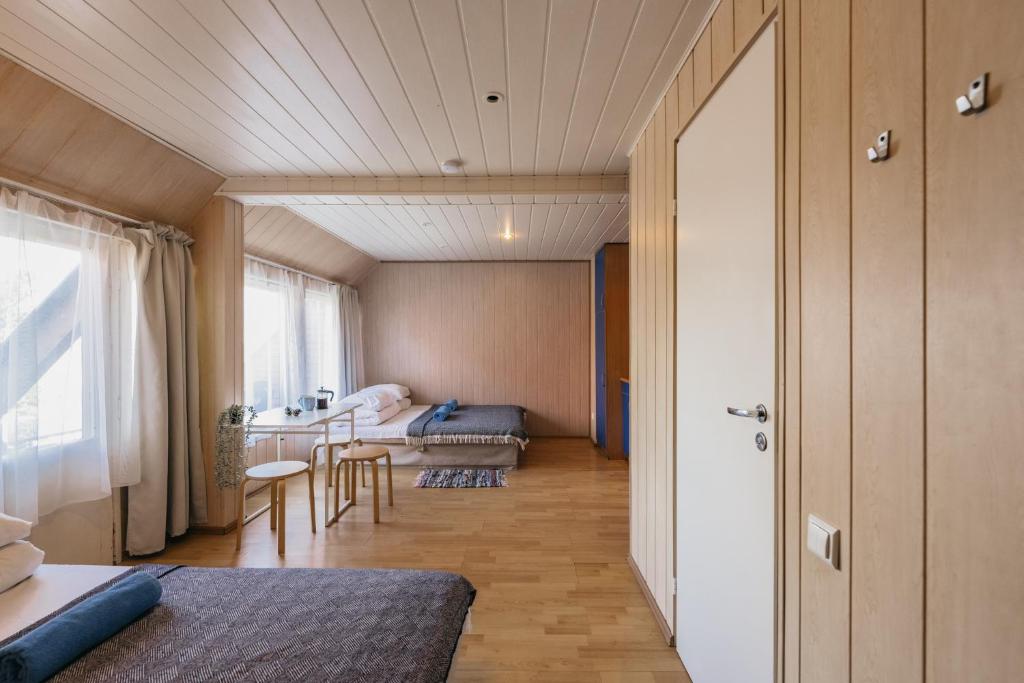 a room with a bed and a living room at Guboja in Nida